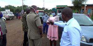 Marimanti Ward MCA Susan Ngugi pictured during her arrest while distributing masks in Kathwana, April 21, 2020.