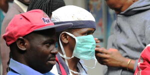 A man spotted wearing a protective facemask as Nairobi County health workers fumigate City Market on March 24, 2020. 