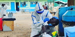 Health officer administers a Covid-19 test on a local at Biafra Medical centre in Kamukunji on Friday, May 15, 2020.