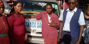 Francis Mwangi Njogu (in maroon shirt) and driver Steven Kiarie (in blue uniform) pose after helping a mother deliver in Kimbo area along the Thika Superhighway on Thursday, February 5
