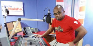 Radio presenter Mate Tongola poses for a photo inside the station's studios on September 27, 2022. 