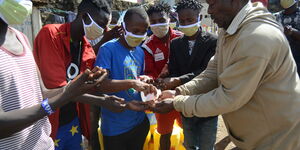 Mathare residents sanitizing their hands in a past event by the Victor Wanyama Foundation, on the 27th March 2020.
