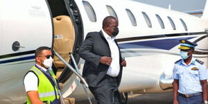 Former Interior CS Fred Matiang'i disembarking from plane in 2021.