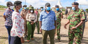 Interior CS Fred Matiang'i (centre) flanked by IG Hillary Mutyambai (right) and other security officials in Kangundo on May 1, 2020.