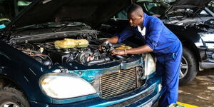 A file image of a mechanic working on a car at a garage