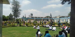 Health workers seated on the grass at the Kenyatta National Hospital  during a go slow on Monday, September 28