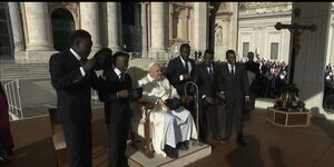 Members of the Black Blue Brothers pose for a photo with Pope Francis at the Vatican 