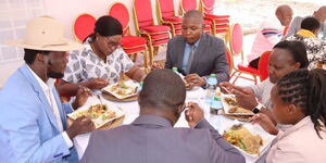 Meru Governor Kawira Mwangaza shares a meal with her spouse and other county officials