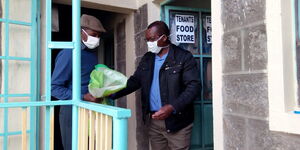 Michael Munene donating foodstuffs to his tenant