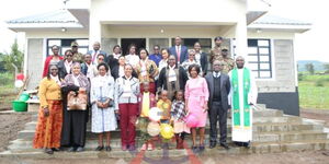 Military Wives Association of Kenya (MWAK) members pose in front of the newly constructed Ksh2.6 million house in Nakuru County