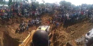Residents of Abimbo village watch at a rescue mission to save miners trapped in the mine on December 2, 2021.