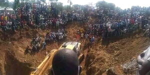 Residents of Abimbo village watch at a rescue mission to save miners trapped in the mine on December 2, 2021. 