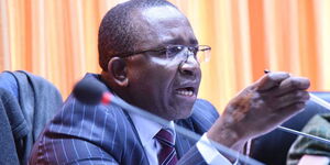 Mithika Linturi gestures during a press address at parliament buildings in 2018