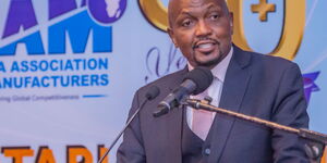 CS Moses Kuria speaking to KAM