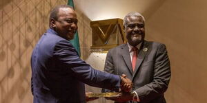 African Union Commission chairperson Moussa Faki (right) and former President Uhuru Kenyatta at an event in 2021. 