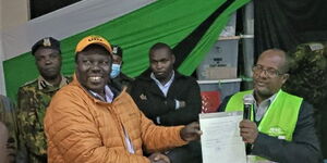 Musa Sirma receiving his election certificate from a IEBC official on August 11, 2022.