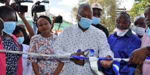 Health CS Mutahi Kagwe launches the Kenyatta National Hospital (KNH) Diagnostic and Reporting Centre, Nairobi in February 2020 as Health CAS Dr Mercy Mwangangi (behind) watches