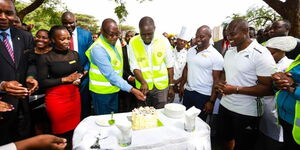 Nairobi Deputy Governor James Njoroge (left) helps Governor Johnson Sakaja (right) cut a birthday cake on Thursday February 2, 2023.