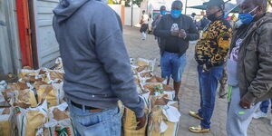 Nairobi Governor Mike Sonko (Black and gold imprinted top) supervising the distribution of essential items in Mua Hills, Machakos County, April 11, 2020.