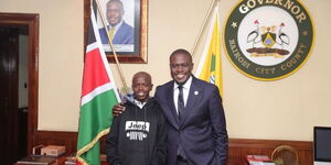 Nairobi governor Johnson Sakaja with a young boy he rescued pose for a photo on Monday, November 14, 2022