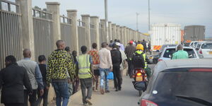 Nairobi residents walking to work due to increased cost of transport within the city.