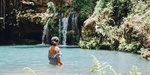 Woman swimming in Ngare Ndare Waterfalls on June 15,2021
