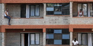 Neighbours converse across the balcony following the social distancing rules to curb the spread of Covid-19.