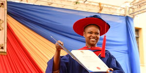 Dr. Purity Ngina, a Strathmore University alumnus, displays her PhD certificate in 2018.