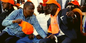 Nominted MP John Mbadi (left) speaks to former Prime Minister Raila Odinga.