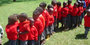 Nursery school children make a queue
