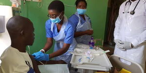 Undated Photo of a Nurse Attending to a Patient at Government Hospital