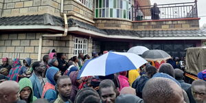 Onlookers at the home of Edward Morema in Nyamira County on March 21, 2023.