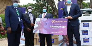Homa Bay Governor Cyprian Awiti receives a donation from Mozzart Country Manager Sasa Krneta