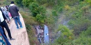 On lookers at the Nithi bridge where a Modern Coast bus veered off rolled several times before landing on the Nithi River bank.