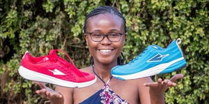 Osembo Navalayo, CEO of Enda Sportswear , holding some of her shoe brands