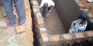 Work on Charles Bukeko's burial site at his home in Busia County