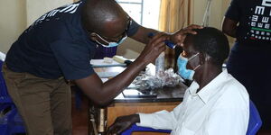 A patient receiving eye treatment in Matayos, Busia County