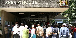 People queue outside Sheria House in Nairobi.
