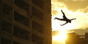 A silhouette of a man falling from a building
