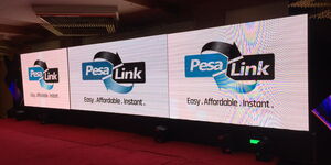 A photo of a PesaLink logo displayed on a screen at a past event.