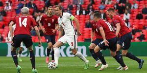 Photo of Harry Kane dribbling past Czech Republic players during the EURO 2020 Finals taken on June 22, 2021, at the Wembley Stadium, England.
