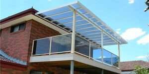 A house roofed using Polycarbonate plastic sheets.