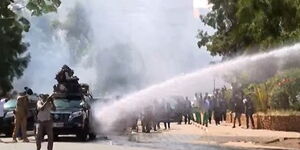 Police officers lob teargas at Azimio leader Raila Odinga's motorcade outside Serena Hotel, Nairobi on Monday, March 20, 2023.