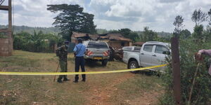 Police officer at the scene of the arson in Kandara, Murang'a County on Sunday, April 10, 2022.