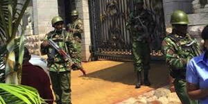 Police officers manning a house.