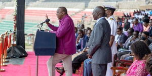 President Uhuru Kenyatta (far left), Labour CS Simon Chelugui and the President's Aide de Camp ( in white) during the Labour Day celebrations at the Nyayo Stadum on May 1, 2022..j