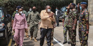 President Uhuru Kenyatta (in brown shirt) with Defence CS Monica Juma arrive at Kenya Meat Commission (KMC) Landhies Road deport on Monday, May 24, 2021.