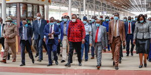 President Uhuru Kenyatta (in red) and other leaders during a tour of Kenya Railways