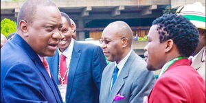 President Uhuru Kenyatta (left) greets Comedian and Nacada Director Vincent Muasya popularly known as Chipukeezy.