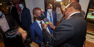 President Uhuru Kenyatta (right) and ICT CS Joe Mucheru at a past function